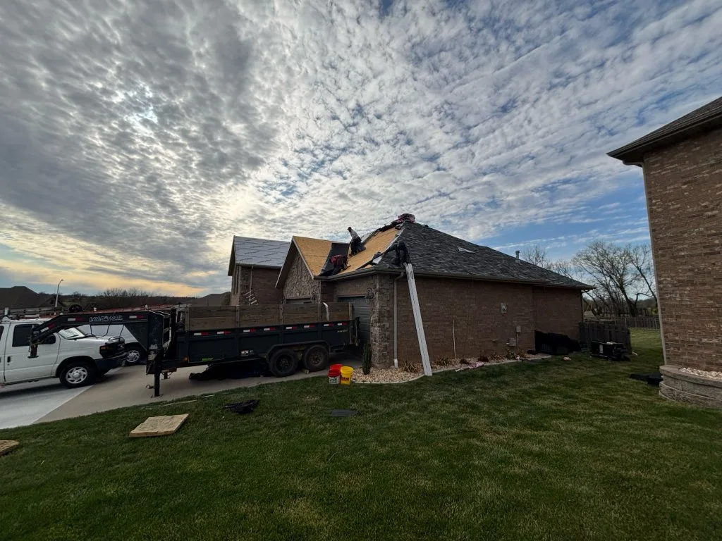 Roofing crew working on an insurance claim replacement