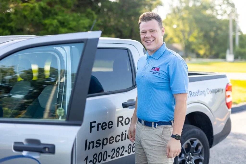SRA roofing technician beside a company truck ready for a residential roof visit